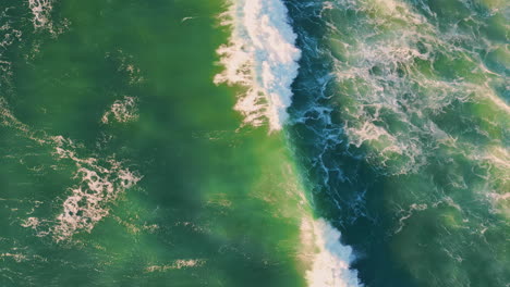 top stormy sea surface waving with foam. drone shot rough ocean waves rippling