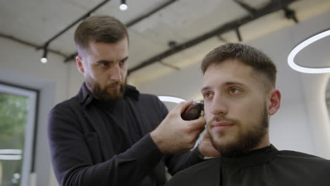 man getting a haircut at a barber shop