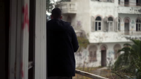 male photographer exploring old abandoned building site, cinematic follow