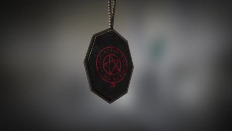 high quality close up render of an unusual metal and stone pagan pentacle amulet with runes, swinging slowly on the end of a neck chain, with super shallow depth of field abd bokeh background