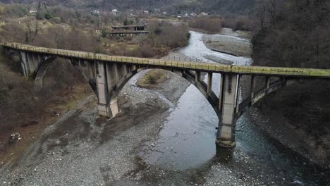 old concrete bridge over a mountain river