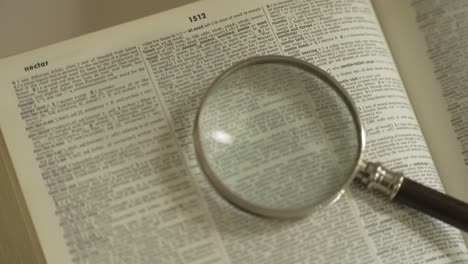 magnifying glass on large opened book