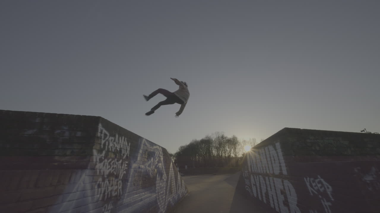 Parkour/Skateboarding stunts at a park
