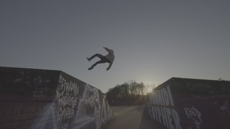 Parkour/Skateboarding stunts at a park