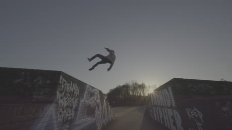 parkour/skateboarding stunts at a park
