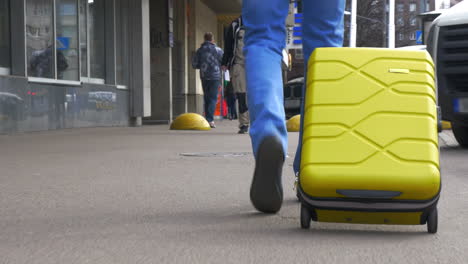 Man-With-A-Suitcase-On-Wheels-In-The-City-Street