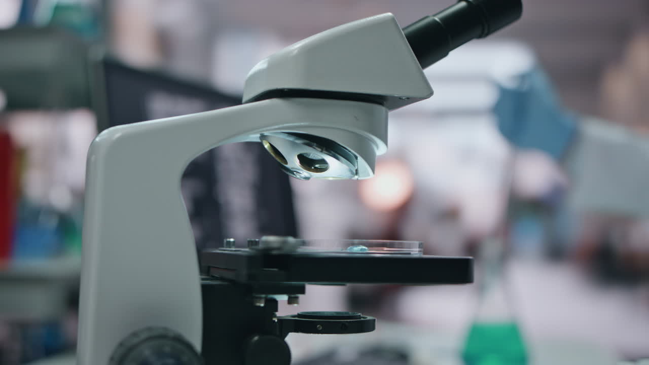 Doctor hand putting sample to microscope using medical pipette in lab close up.