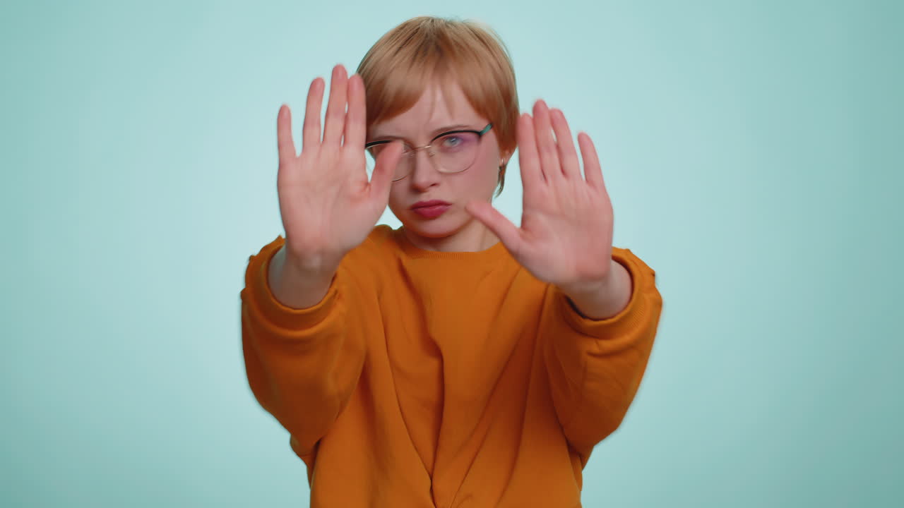 Woman say no hold palm folded crossed hands in stop gesture warning of finish prohibited access