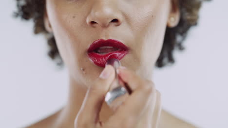 woman applying red lipstick