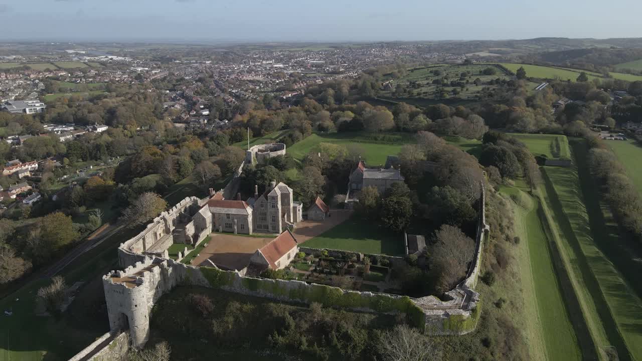 Castle a great fortress which began life as an Anglo-Saxon earthwork defence against Viking raids. Drone rotating to the left showing the castle, the buildings and the green fields around the castle