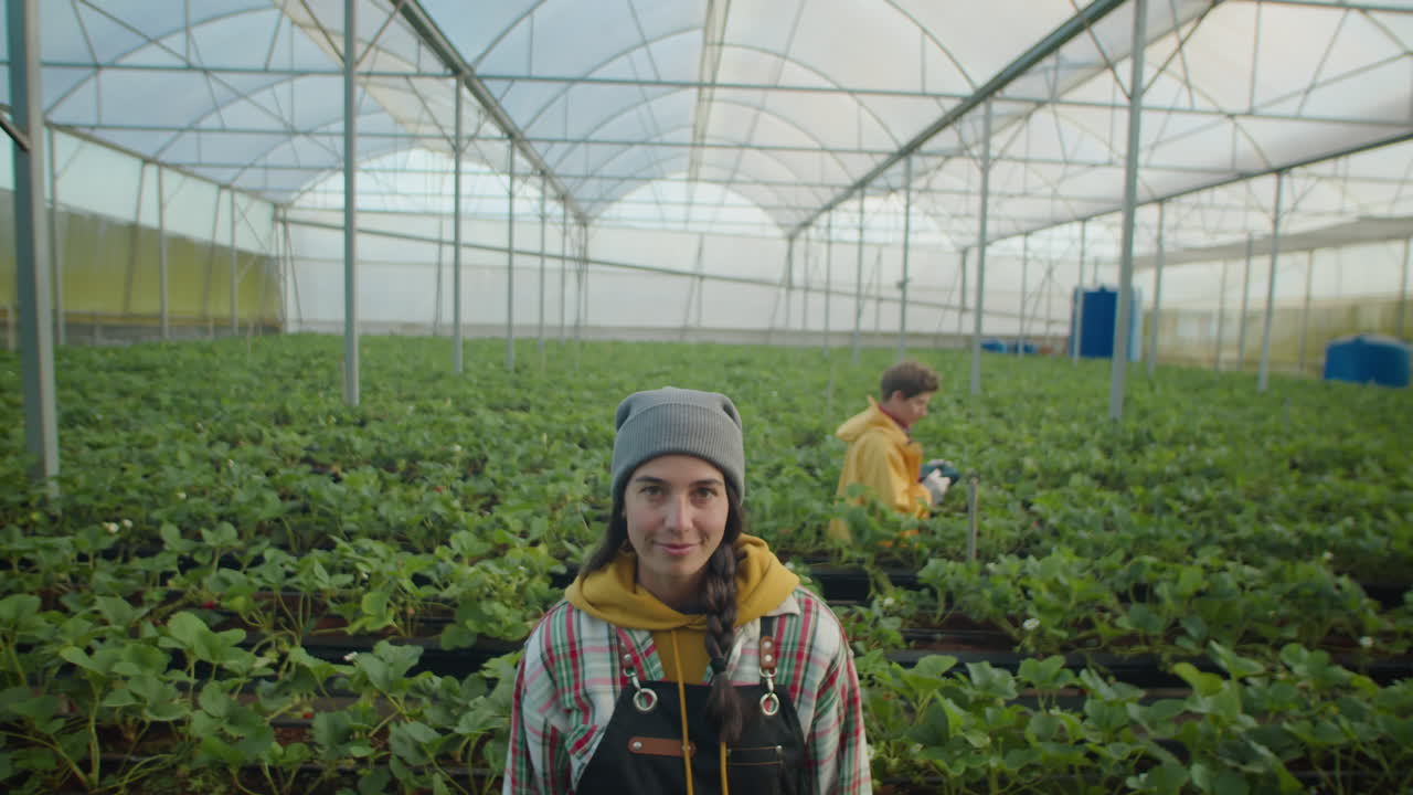 Portrait of Young Female Farm Worker in Greenhouse