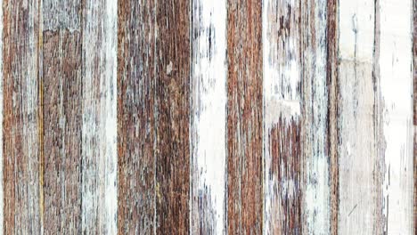 4k seamless looping motion fast moving background from grunge weathered old wooden planks texture. natural aging outdoors under the sun and rain. vertically oriented moving from top to bottom video.