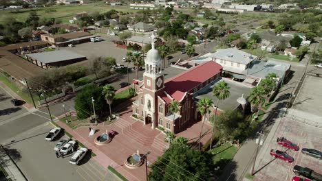 Ascending-aerial-view-of-"Our-Lady-of-Guadalup"-Church,-one-of-the-oldest-landmarks-in-Mission,-Texas,-dating-back-to-1899