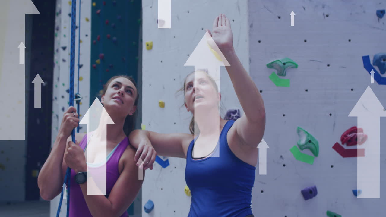 Animation of arrows over caucasian women by climbing wall