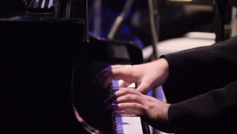 close-up view of a pianist playing the piano