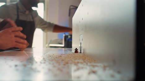 Carpenter-performing-tasks-on-wood-shaper,-shaping-materials,-close-up