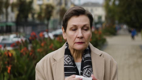 woman sneezing in the middle of the street