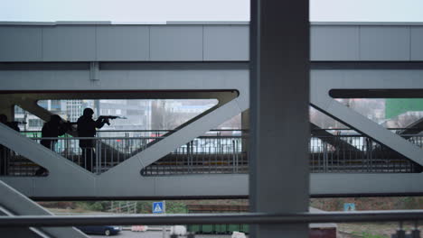 Special forces squad protecting urban bridge with assault rifles
