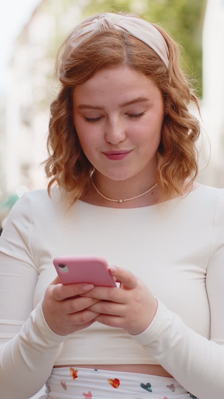 Young woman using smartphone typing text messages looking for a way on map in mobile navigator app
