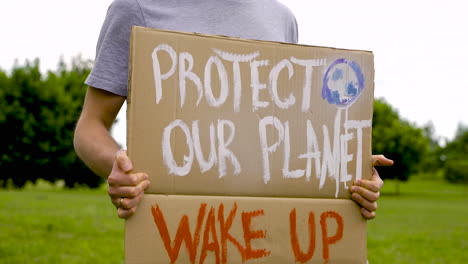 close up of a man holding a placard