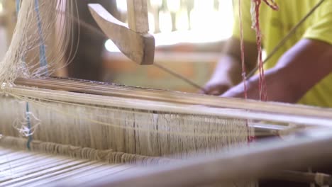 weaving-silk-cotton-close-up-to-workers-on-wooden-mechanical-machine