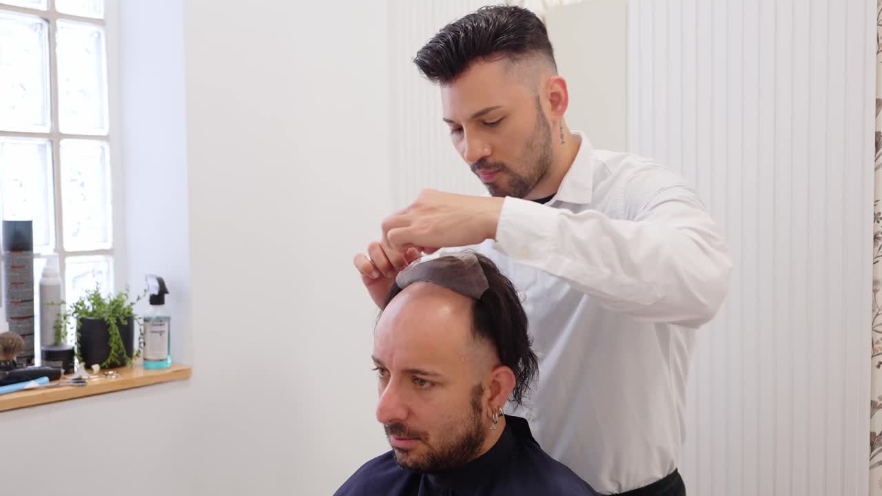 Hair Stylist Applying Toupee to Male Client