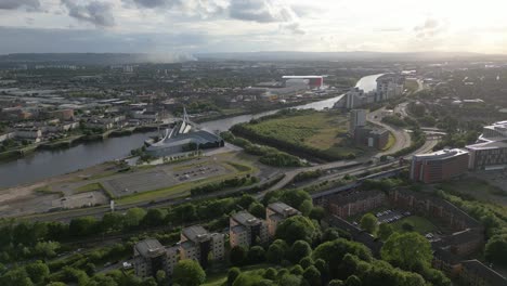 aerial fly towards riverside museum with winding river clyde through the beautiful environment, glasgow, scotland, uk