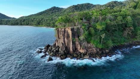 the rugged west coast of weh island with lush forest and clear waters, aerial view