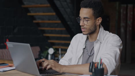 young man working on laptop in home office