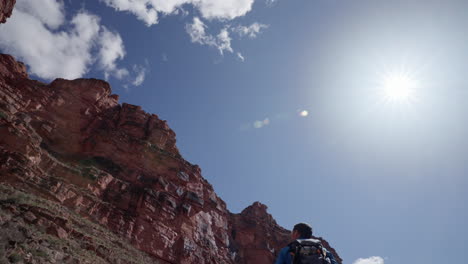 photographer taking in his surroundings during a hike in the southwestern deserts of arizona and the grand canyon on a sunny afternoon outdoors