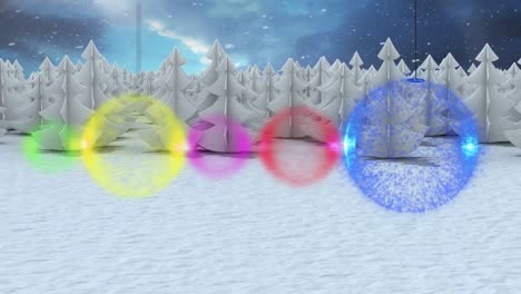 colorful baubles decorations against snow falling over winter landscape against night sky