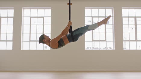 fit aerial yoga woman practicing poses using hammock enjoying fitness lifestyle exercising in studio training meditation at sunrise