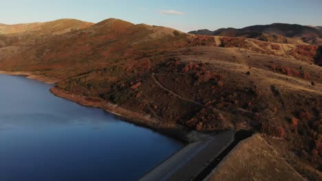 aerial push in above little dell reservoir during sunset fall utah, usa