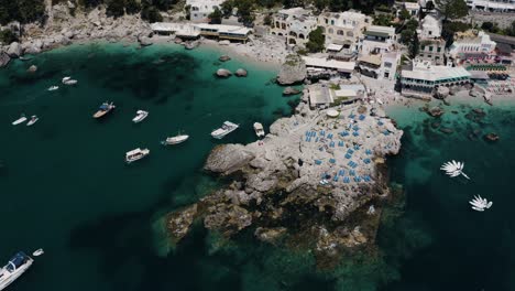 Drone-shot-of-Capri,-Italy's-unique-sunbathing-coast-line,-perfect-for-tourists