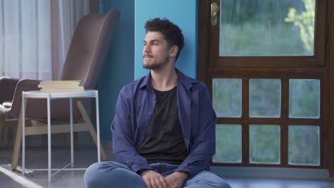 depressed man shaking his head with negative expression.