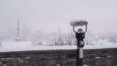 heavy snowfall in tallinn estonia, viewed from the panoramic platform over the city hiding in fog and snow