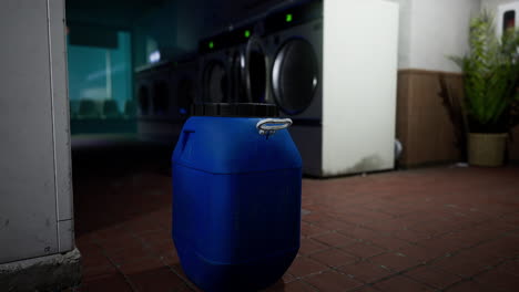 a lonely blue barrel in the abandoned laundromat