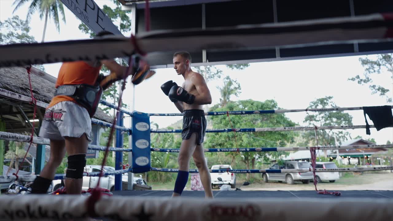 Muay Thai Athletes Training in a Boxing Ring