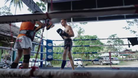 muay thai athletes training in a boxing ring