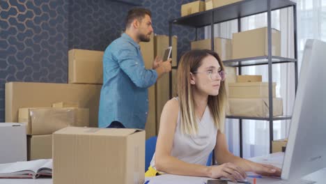 entrepreneurial couple working in e-commerce office. selling online.