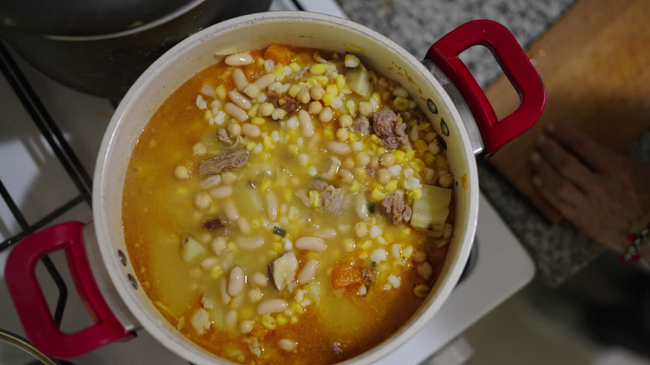 A rich, hearty stew being cooked—Locro, a symbol of Argentine cultural heritage - top down view.