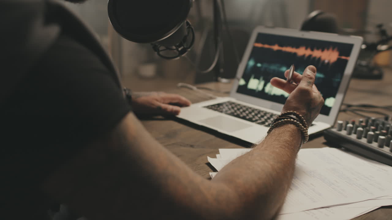 Unrecognizable Podcast Host Talking Into Microphone