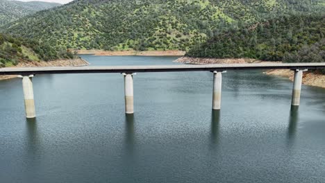 the don pedro reservoir bridge stands tall in this aerial footage, linking roads over the shimmering california waters.