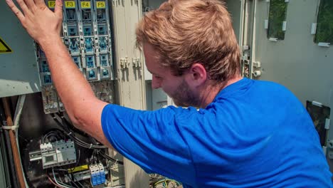 technician checking solar panel control box. follow shot