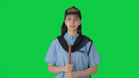 Happy-Indian-female-security-guard-listening-to-someone-Green-screen