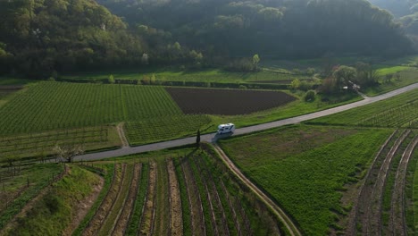 motorhome crossing a farmland road. aerial view