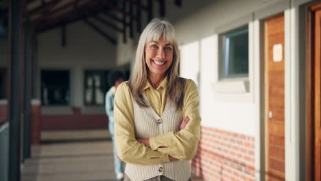 Portrait of a smiling teacher in a school hallway