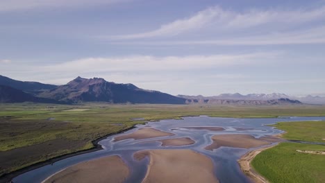 aerial footage of river delt with birds flying by during sunny summer in snaefellsness peninsula, iceland