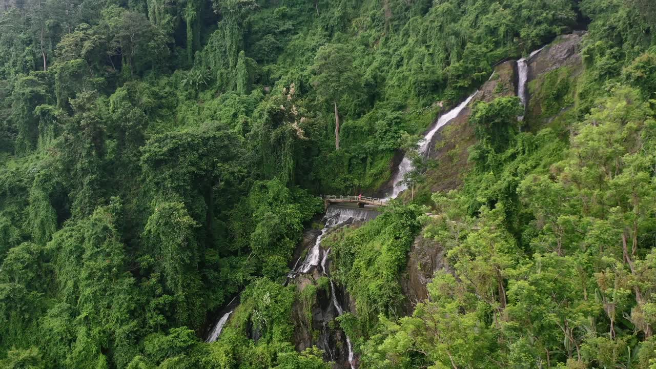 Waterfall On A Mountain Jungle Rock In Lombok Indonesia On Cloudy Day,  Aerial Free Stock Video Footage Download Clips