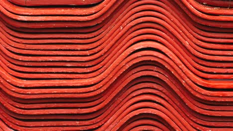 stacked red corrugated metal sheets